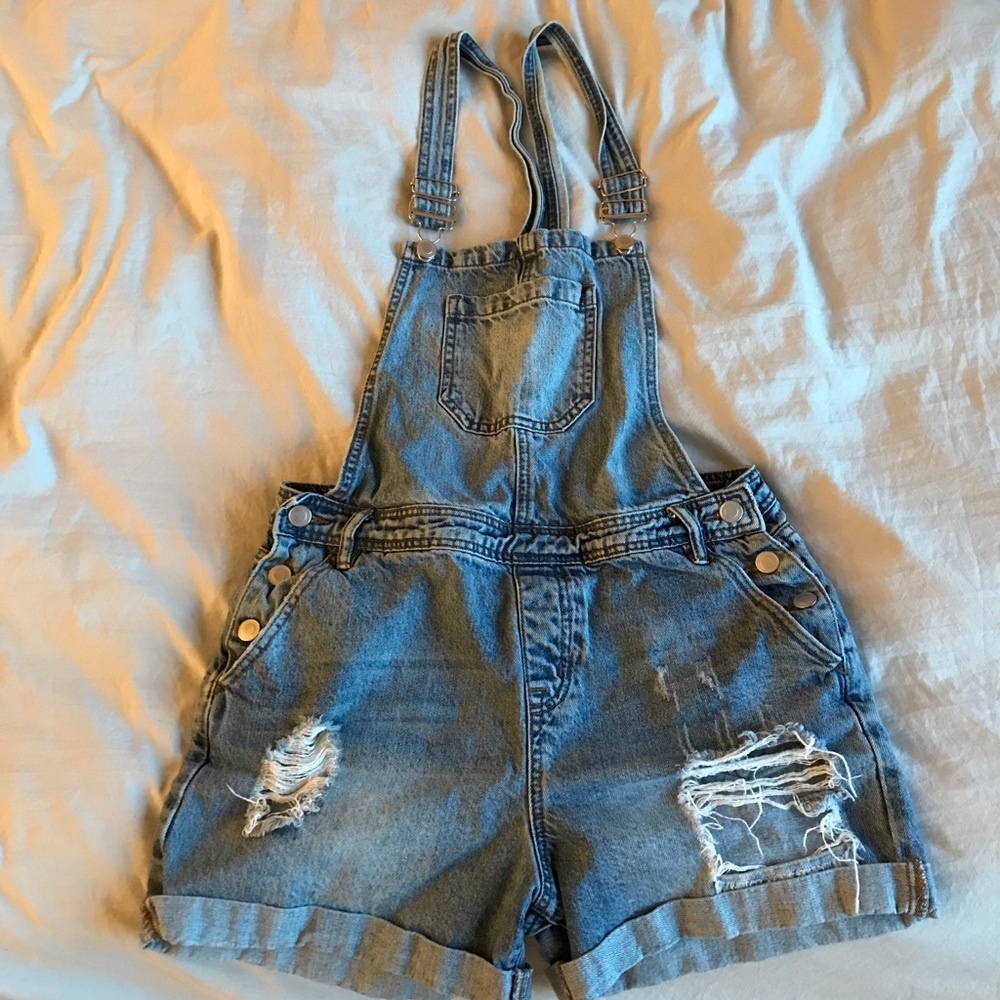 Overall shorts size M with rips on thighs. Still in great condition!